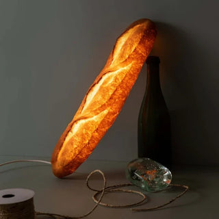 Pampshade bread lamp glowing warm against a dark wall