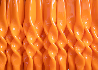 Glossy orange Meloria twisted dinner candles, hand-lacquered in Tuscany